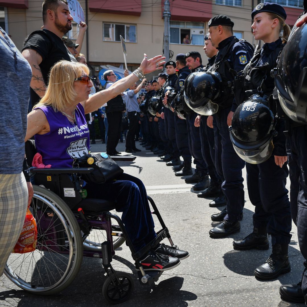 An anti-government protester shouts at supporters of Romania's Social Democratic Party (PSD) coming to attend an EU elections rally in Targoviste on May 19, 2019.