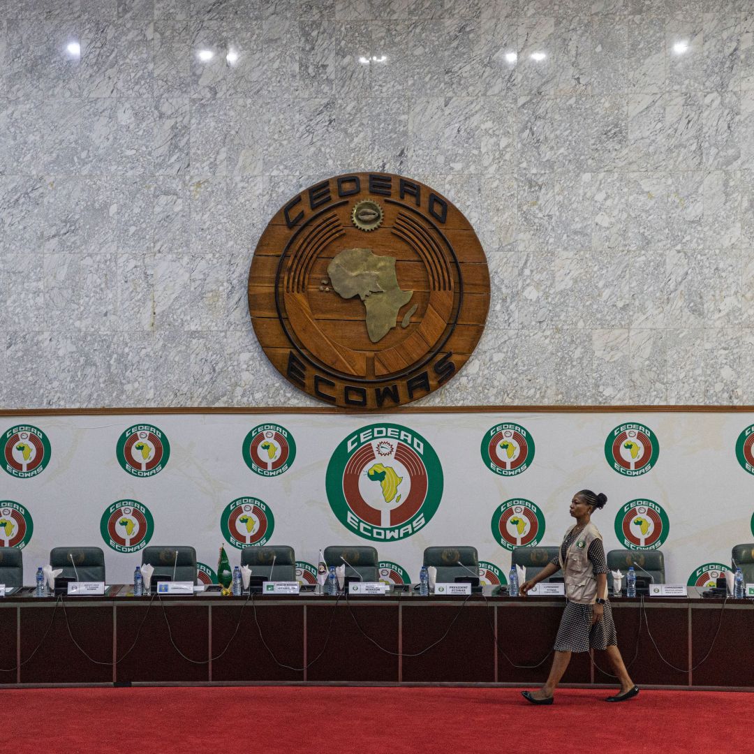 A staff member walks past a stage before a press conference at the Economic Community of West African States (ECOWAS) headquarters in Abuja, Nigeria, on Feb. 27, 2023. 