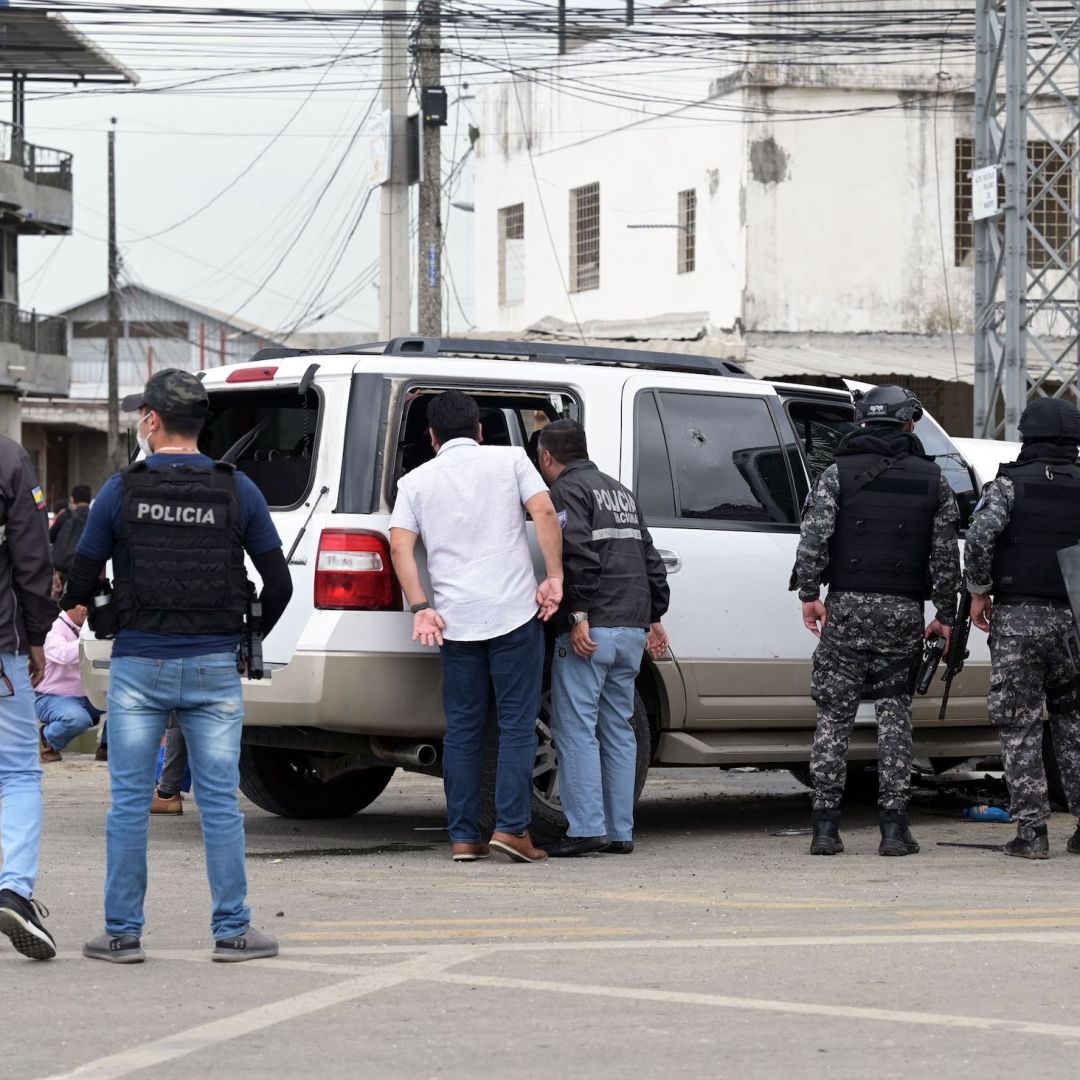 Policemen guard the car of Mayor Luis Chonillo after an attack on the official May 15, 2023, in Duran, Ecuador.