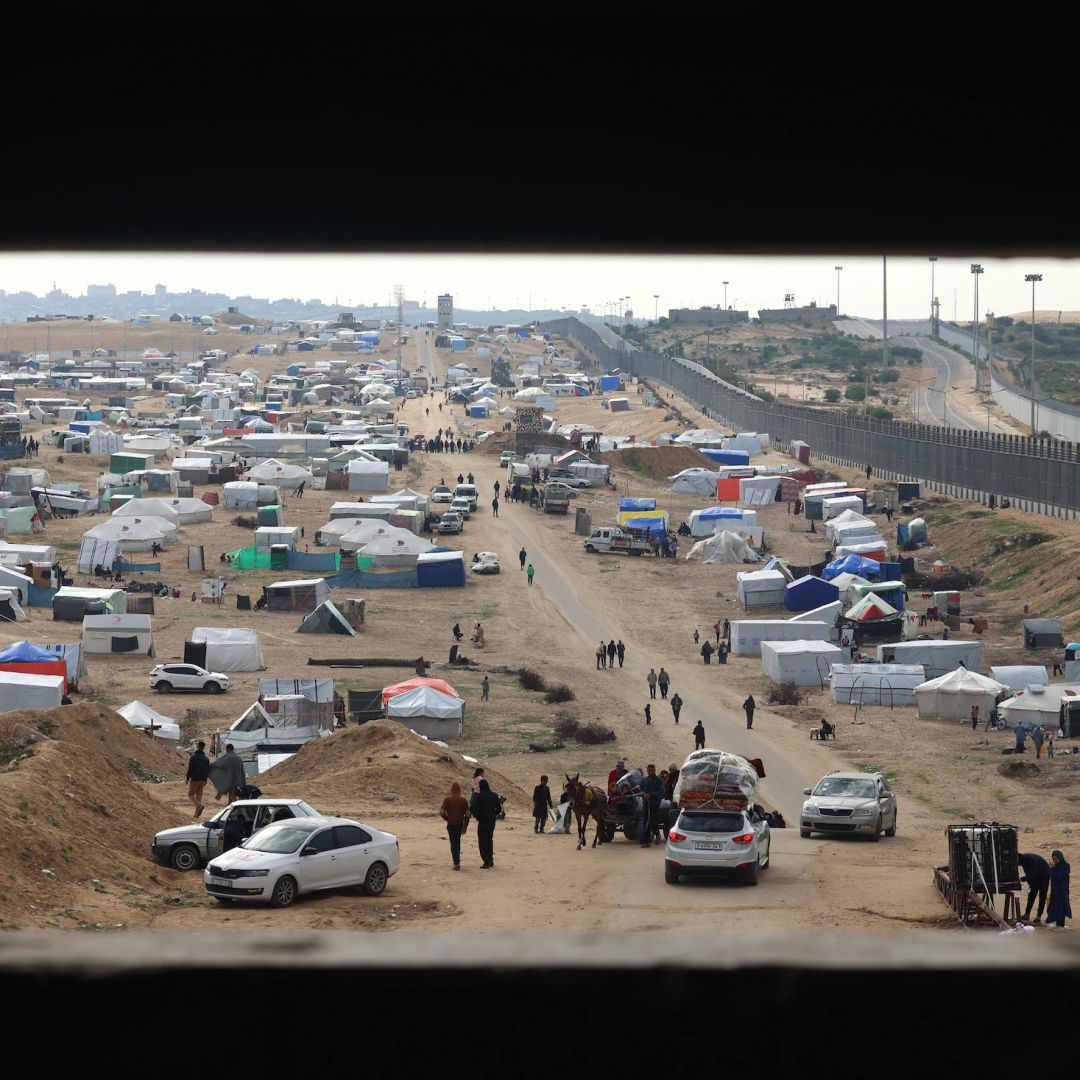 Displaced Palestinians camp near the fence separating the Gaza Strip from Egypt on Feb. 16, 2024, in the southern Gaza city of Rafah.