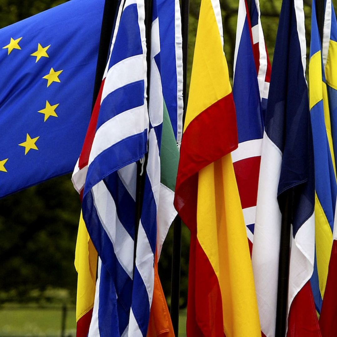 A man checks the flags of EU countries in 2004. A man checks the flags of EU countries in 2004.