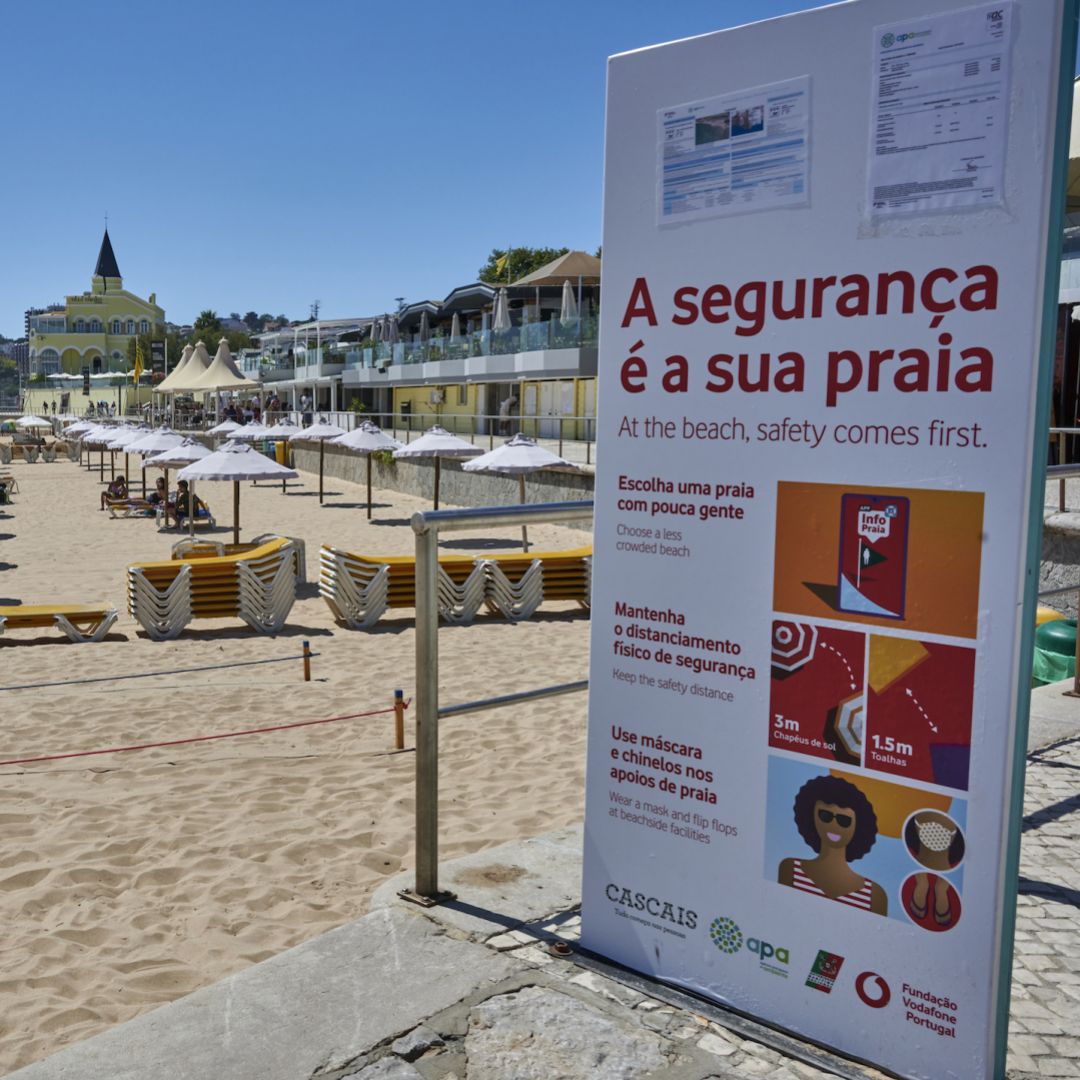 A large billboard alerts beachgoers of COVID-19 safety measures in Praia do Tamariz, a favorite spot for locals and tourists, on July 29, 2020, in Estoril, Portugal. 