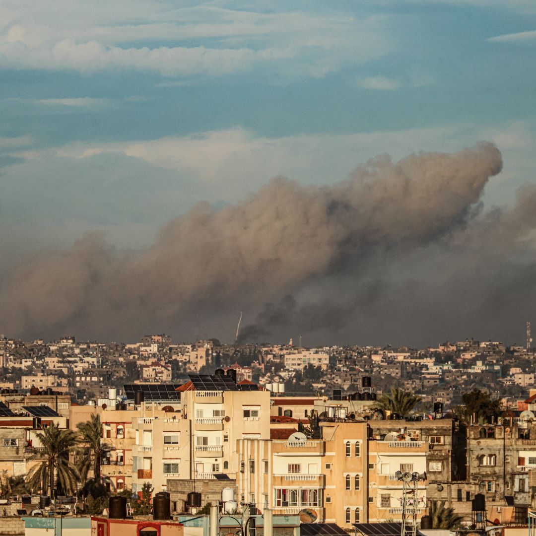 A picture taken from Rafah in the southern Gaza Strip shows smoke rising over buildings in Khan Yunis during an Israeli bombardment on Feb. 2, 2024. 