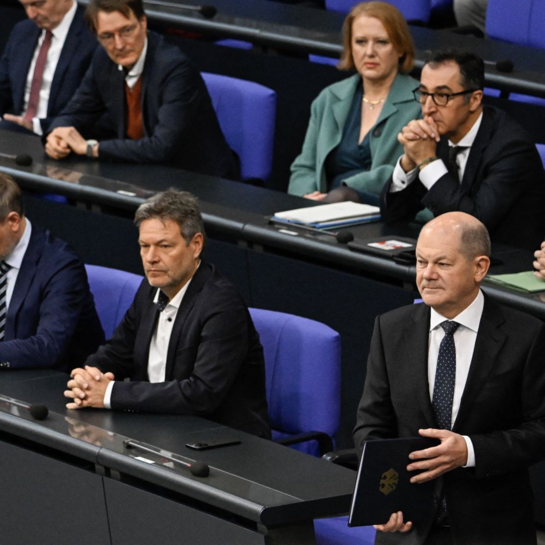 German Chancellor Olaf Scholz prepares to deliver a speech in parliament about the budget crisis on Nov. 28, 2023, as Interior Minister Nancy Faeser (left), Finance Minister Christian Lindner and Economy Minister Robert Habeck look on. 