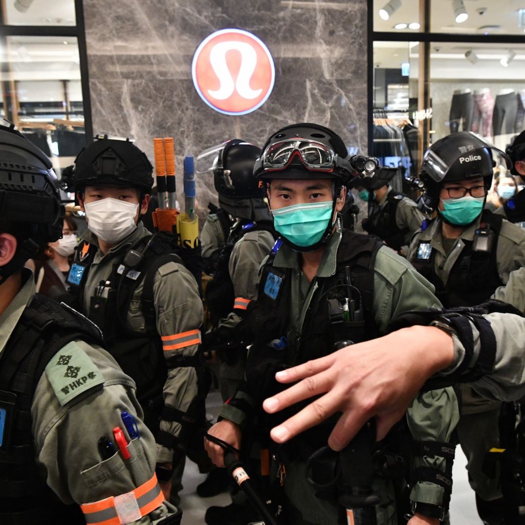 Riot police wear face masks, as a precautionary measure against the COVID-19 coronavirus, as they carry out a crowd dispersal operation in a shopping mall during a protest by pro-democracy supporters in the town of Shatin in Hong Kong on May 1, 2020. Riot police wear face masks, as a precautionary measure against the COVID-19 coronavirus, as they carry out a crowd dispersal operation in a shopping mall during a protest by pro-democracy supporters in the town of Shatin in Hong Kong on May 1, 2020.