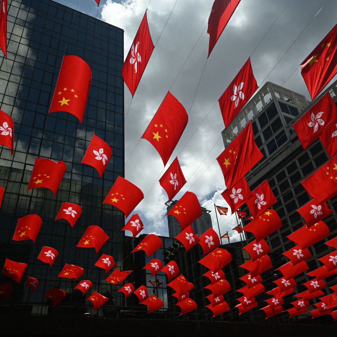 Chinese and Hong Kong flags are strung between buildings to mark the 26th anniversary of the city's handover from Britain to China on June 27, 2023, in Hong Kong.