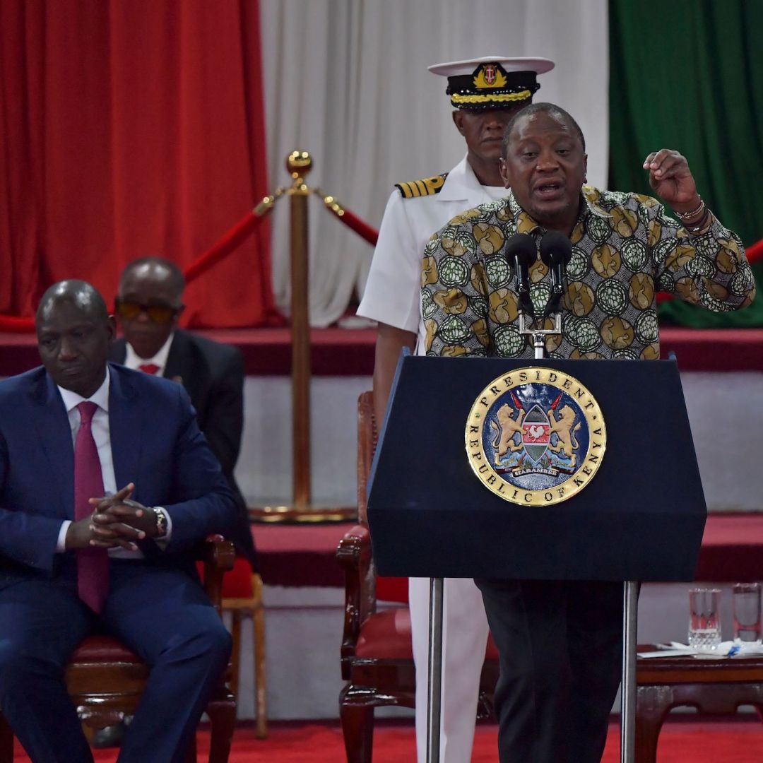 Kenyan Deputy President William Ruto (left) and opposition leader Raila Odinga (right) listen to President Uhuru Kenyatta (center) give a speech in Nairobi, Kenya, on Nov. 27, 2019. 