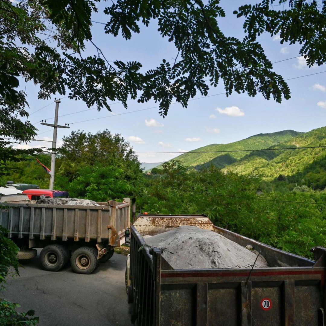 Trucks loaded with sand form a barricade in a road near the Kosovar town of Zubin Potok on Aug. 1.