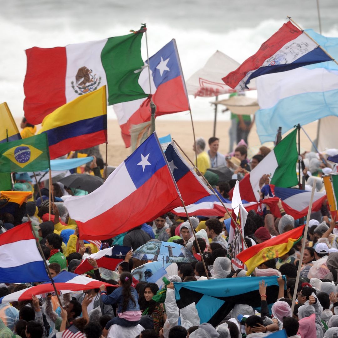 Pilgrims with flags from different countries gather at Copacabana beach in Rio de Janeiro, Brazil, on July 23, 2013, as they wait for the official opening of the Catholic Church's World Youth Day, which will be celebrated with a holy Mass. 