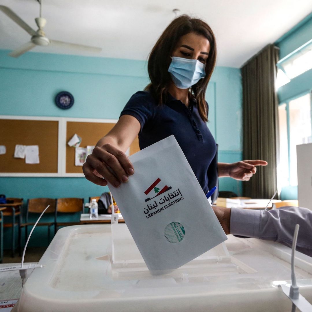 A voter casts her ballot in Lebanon's May 15, 2022, parliamentary election at a polling station in the southern suburbs of Beirut. A voter casts her ballot in Lebanon's May 15, 2022, parliamentary election at a polling station in the southern suburbs of Beirut.