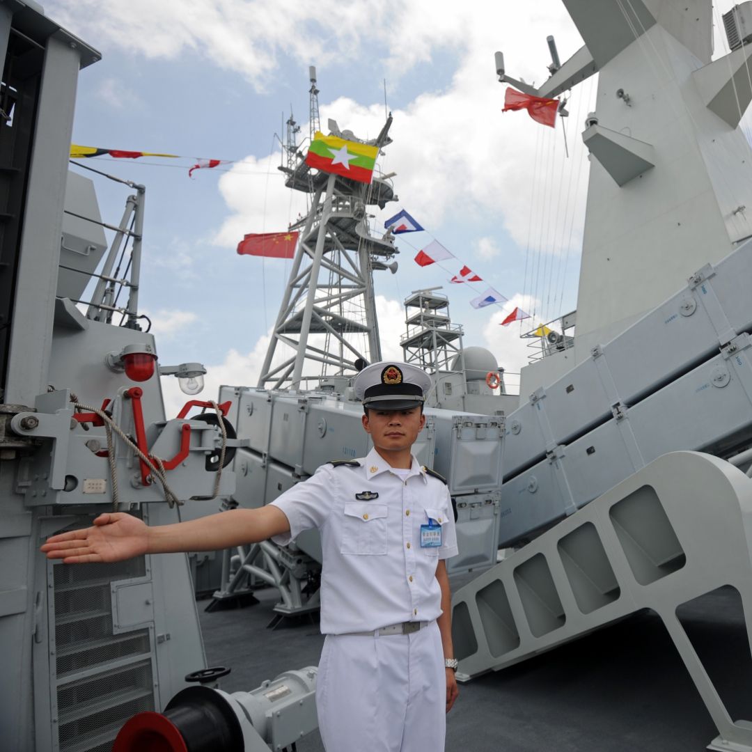 A crew member stands guard on the deck of the Chinese People's Liberation Army Navy ship Wei Fang, docked at the Myanmar International Terminal Thilawa port on the outskirts of Yangon on May 23.