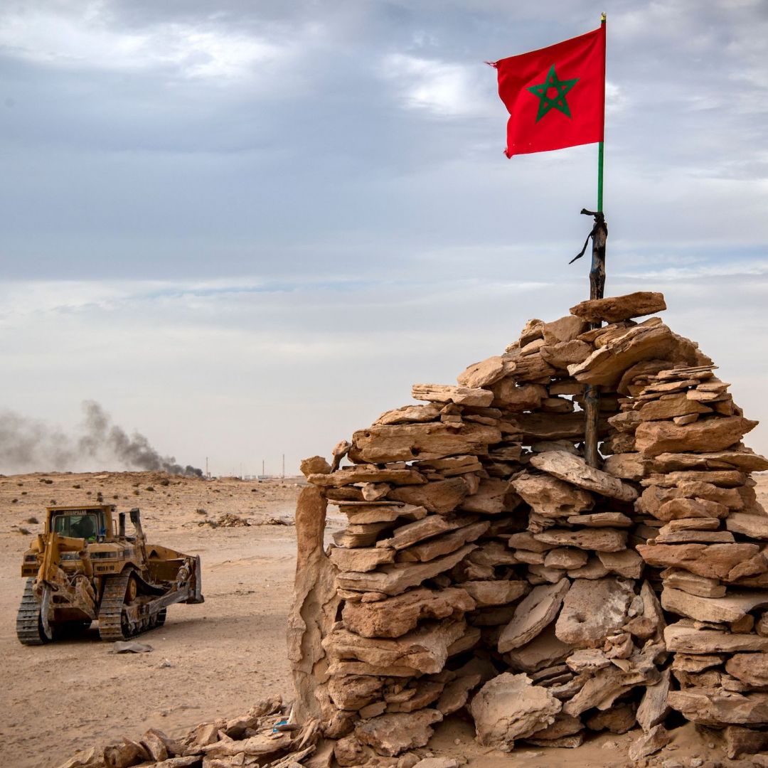A bulldozer passes by a hilltop manned by Moroccan soldiers in Western Sahara on Nov. 23, 2020.