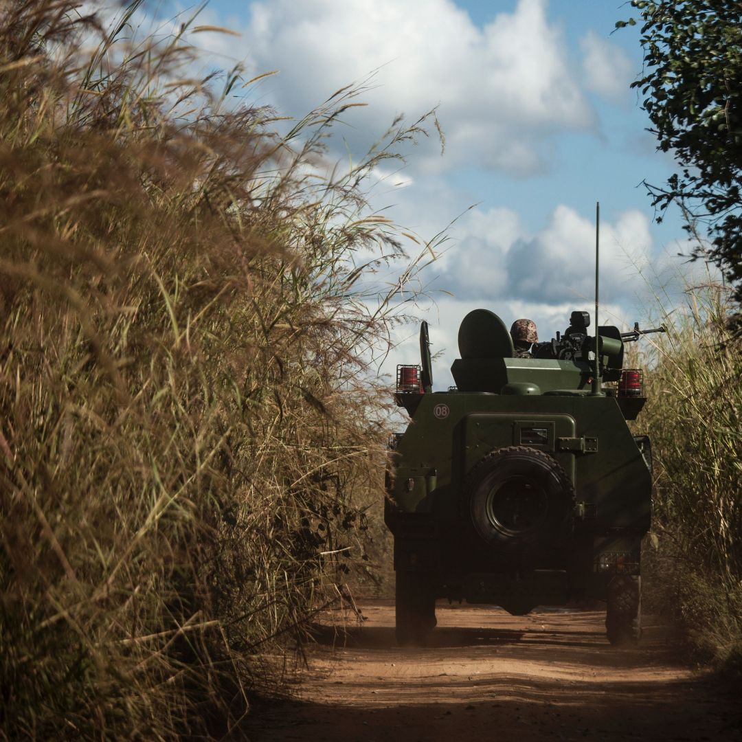 Army vehicles patrol the roads on the outskirts of a village in northern Mozambique on May 26, 2016. 