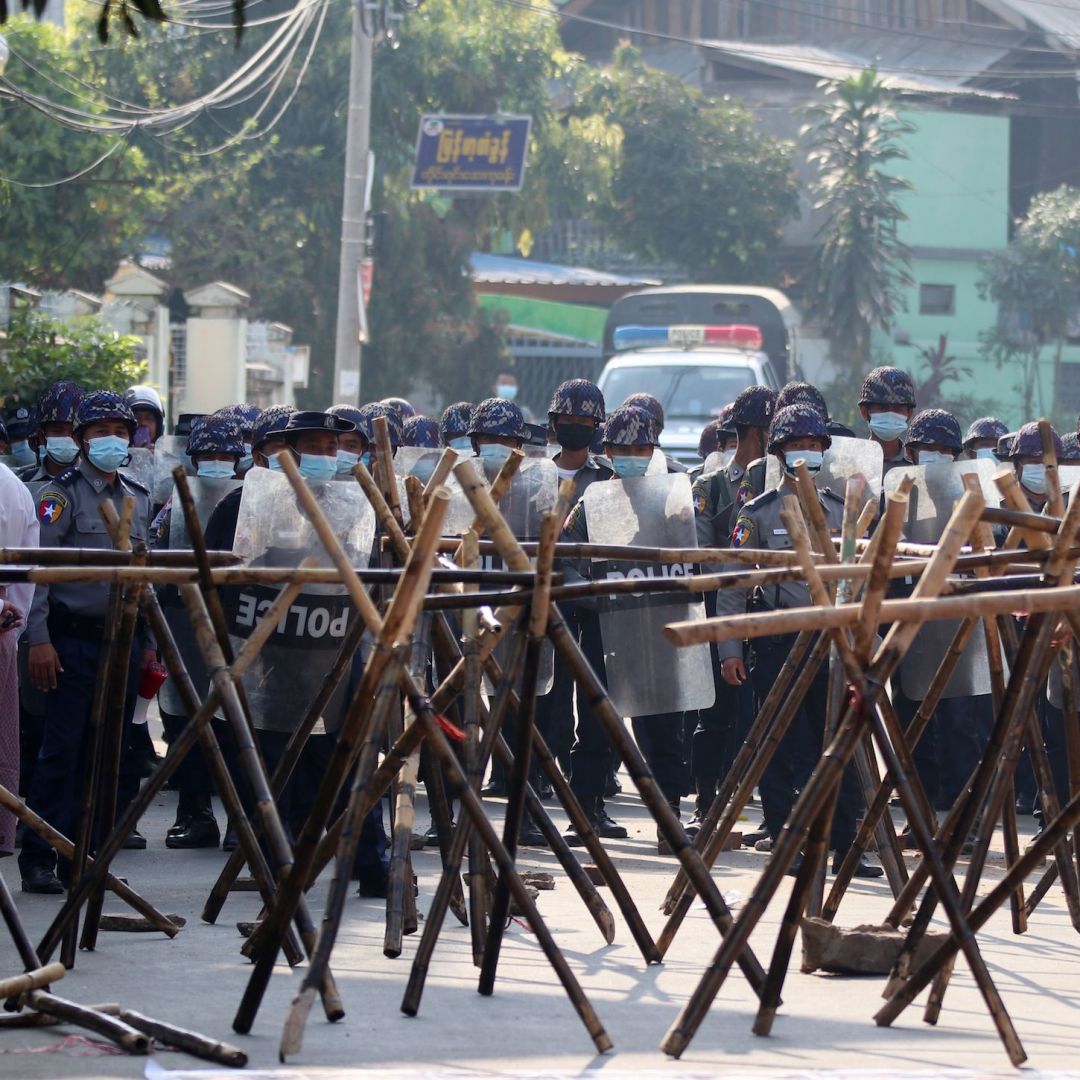 Riot police approach protesters' barricades in an attempt to disperse a March 4, 2021, demonstration in Naypyidaw, Myanmar, against the military coup.