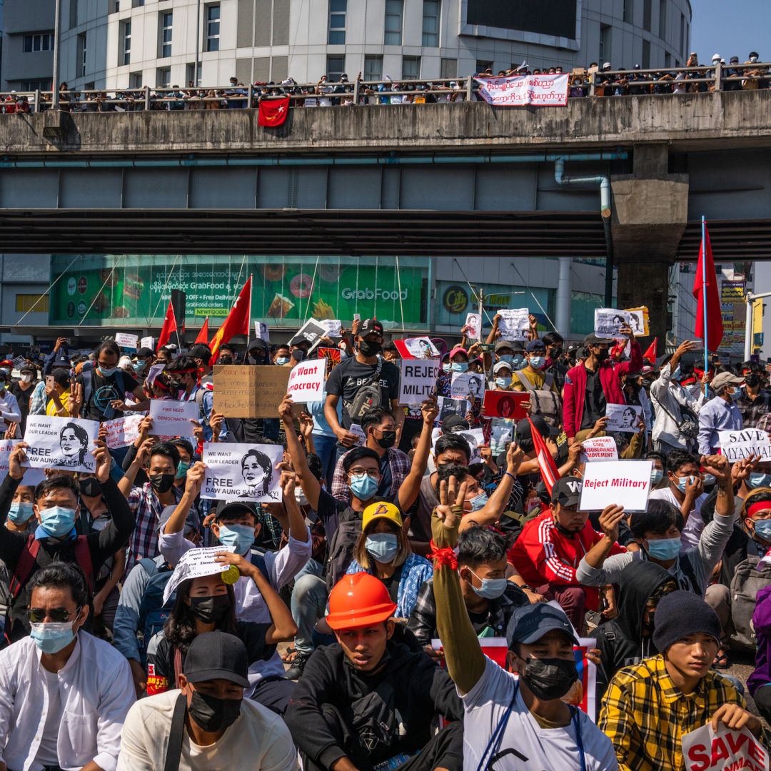 Anti-coup protesters wave red National League For Democracy (NLD) flags and raise three-finger salutes on Feb. 9, 2021, in Yangon, Myanmar. Anti-coup protesters wave red National League For Democracy (NLD) flags and raise three-finger salutes on Feb. 9, 2021, in Yangon, Myanmar.