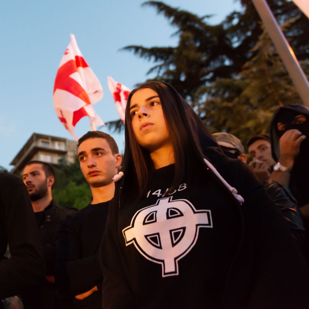 A young Georgian, right, wears a T-shirt with the Stormfront logo and the number 14/88 during a September 2016 rally. The number 14 denotes David Lane’s 14-word white supremacist mantra while 88, as the eighth letter of the alphabet, signifies HH, which stands for Heil Hitler.