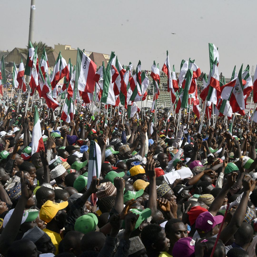 Supporters hold flags to support opposition PDP candidate Atiku Abubakar during a campaign rally in Kano state in northwestern Nigeria on Feb. 9, 2023.