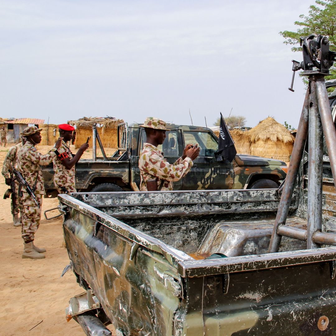 Soldiers take snapshots of vehicles allegedly belonging to ISWAP in Baga, Nigeria, on Aug. 2, 2019.