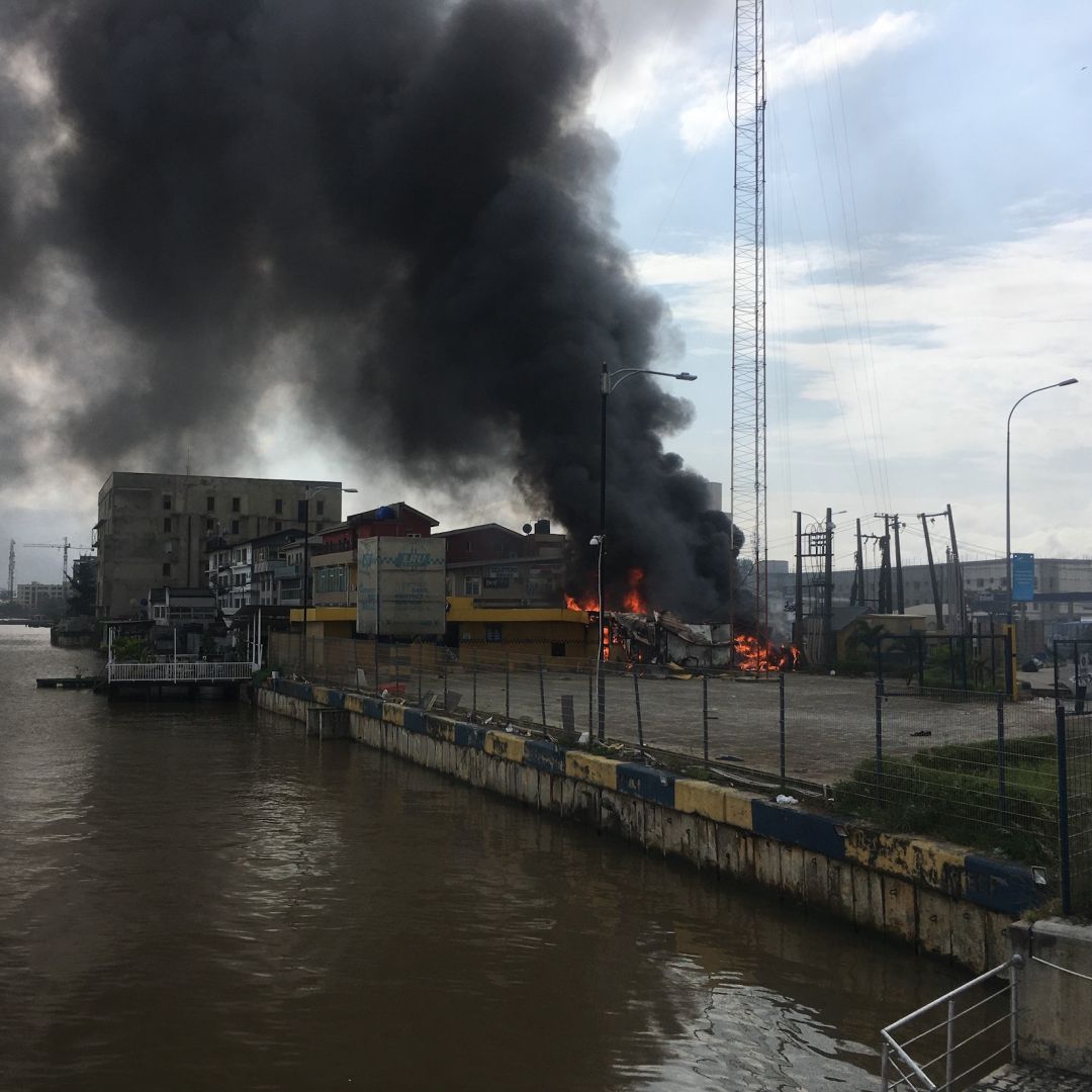 A building remains on fire in Lekki, Nigeria, on Oct. 21, 2020, after #EndSARS protests escalated into violent clashes with police the previous night. 