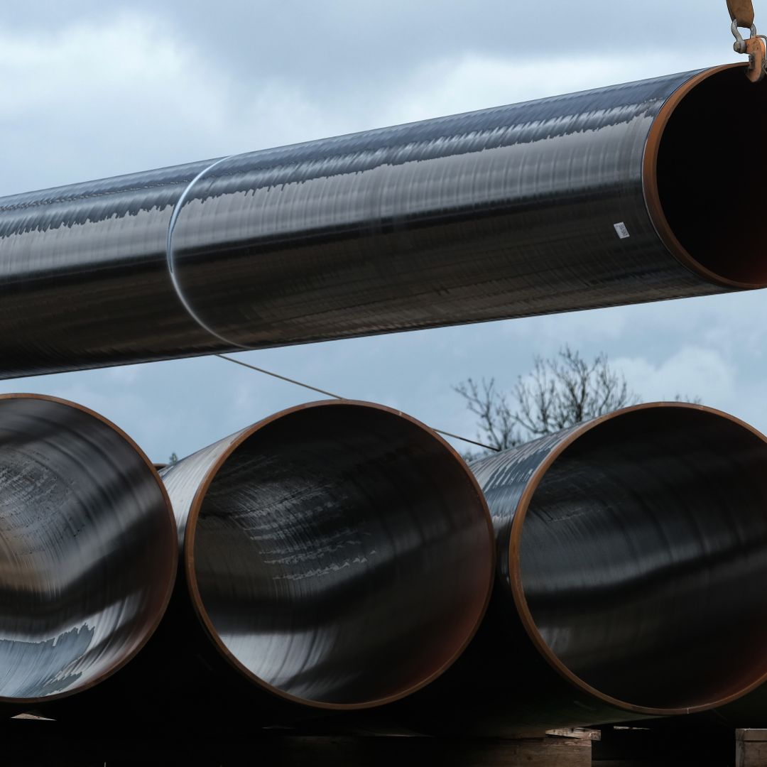 A section of pipe hangs from a crane at a construction site of the Eugal gas pipeline in Germany, which will transport natural gas arriving from Russia through the Nord Stream 2 pipeline.