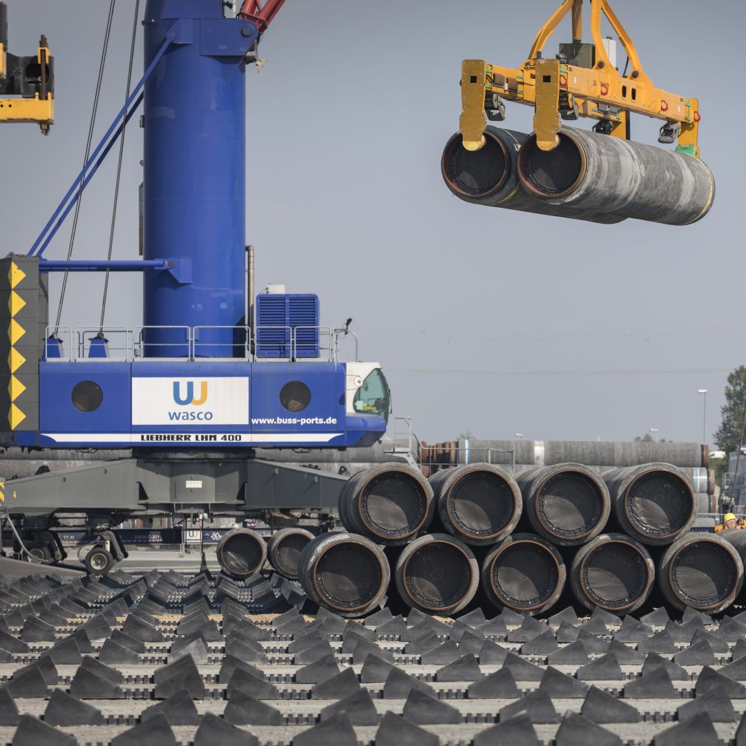 A crane moves Nord Stream 2 pipes at a port near Sassnitz, Germany, on June 5, 2019. 