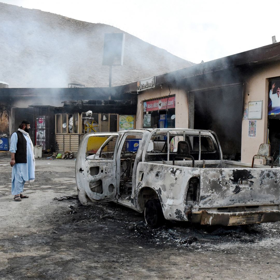 A man looks at damage from a Balochistan Liberation Army attack Jan. 30 in central Bolan district in Balochistan province, Pakistan.