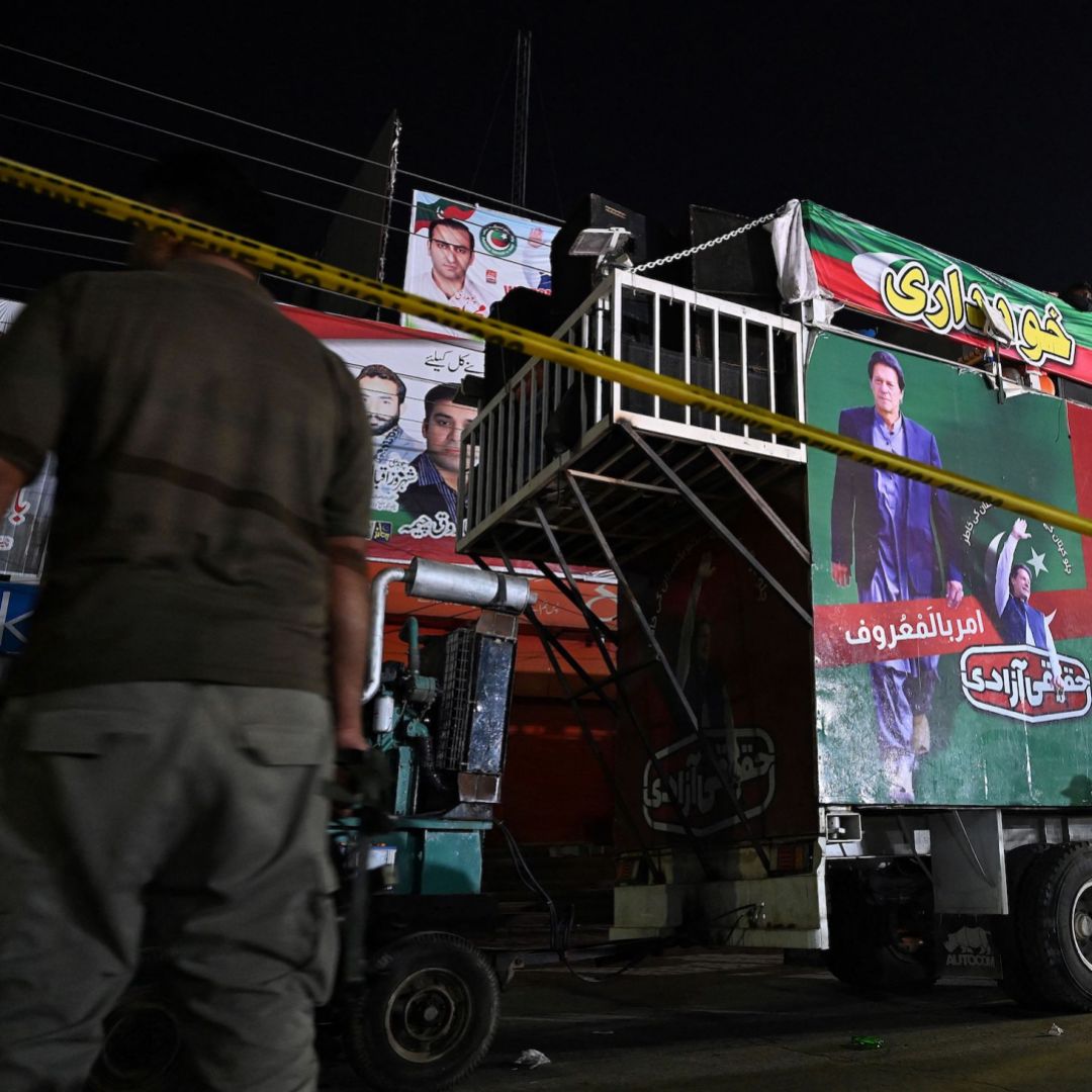 A policeman stands guard beside a container truck near the site of a gun attack against former Pakistani Prime Minister Imran Khan in Wazirabad on Nov. 3, 2022. A policeman stands guard beside a container truck near the site of a gun attack against former Pakistani Prime Minister Imran Khan in Wazirabad on Nov. 3, 2022.