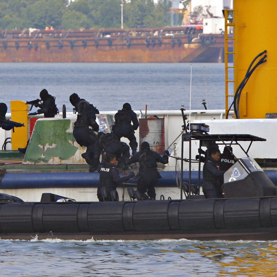 Royal Malaysian Police Special Forces personnel storm a mock hijacked ship during an anti-piracy demonstration exercise June 13, 2007, in Port Klang, Malaysia.
