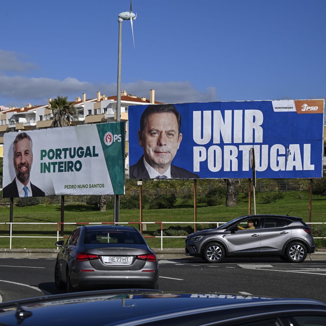 A photo taken on Jan. 20, 2024, shows cars driving by campaign billboard posters in Sao Pedro do Estoril, Portugal, ahead of the country's March 10 parliamentary elections. 