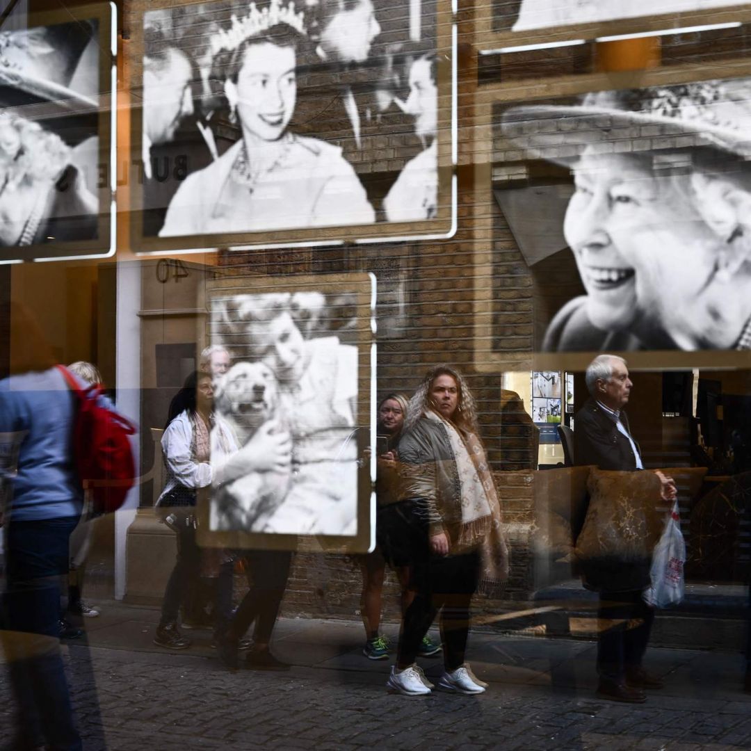 Pictures of Britain's Queen Elizabeth II in a window as members of the public wait in line to pay their respects to the late monarch Sept. 16, 2022, in London. The state funeral for Queen Elizabeth II will occur in London with hundreds of international leaders in attendance. Pictures of Britain's Queen Elizabeth II in a window as members of the public wait in line to pay their respects to the late monarch Sept. 16, 2022, in London.