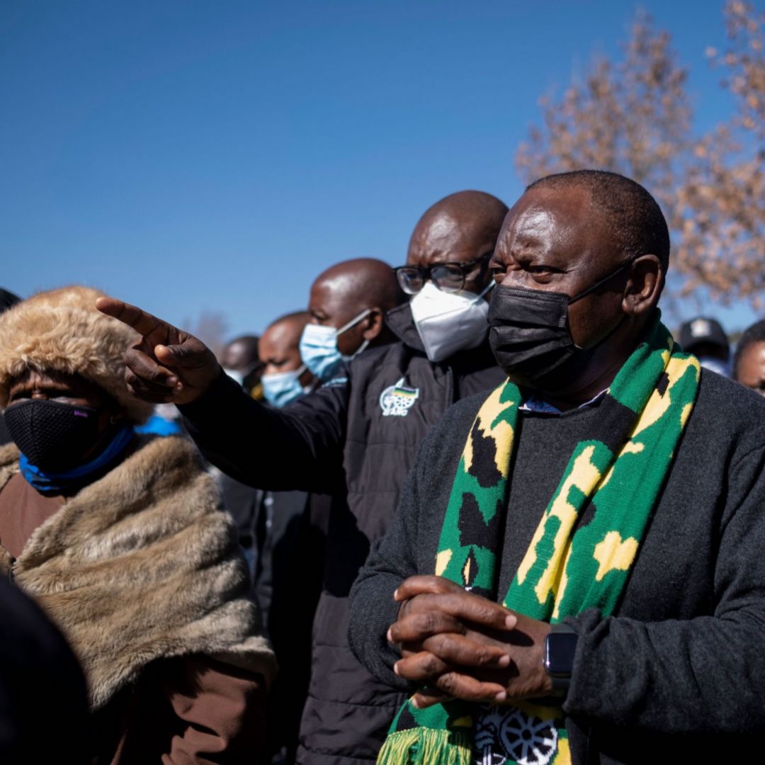 South African President Cyril Ramaphosa (center) visits a mall in Soweto that was damaged by looters on July 18, 2021.