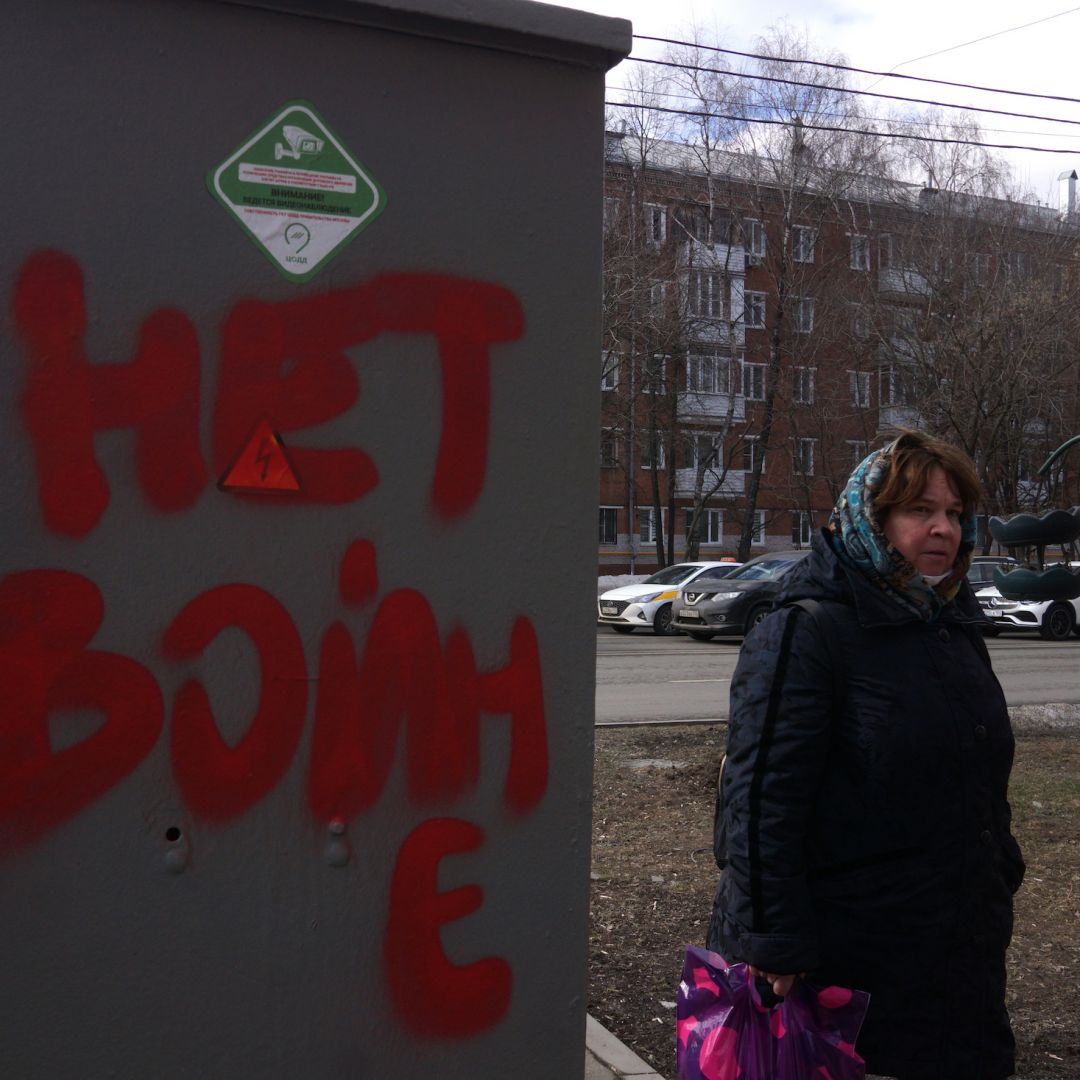 A woman walks past graffiti that reads, "No war," on March 14, 2022, in Moscow, Russia. 