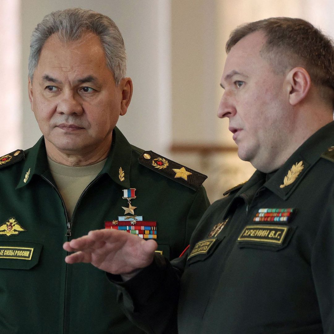 Russian Defense Minister Sergei Shoigu (L) speaks with his Belarusian counterpart, Viktor Khrenin, on Feb. 3, 2022, in Minsk, Belarus.