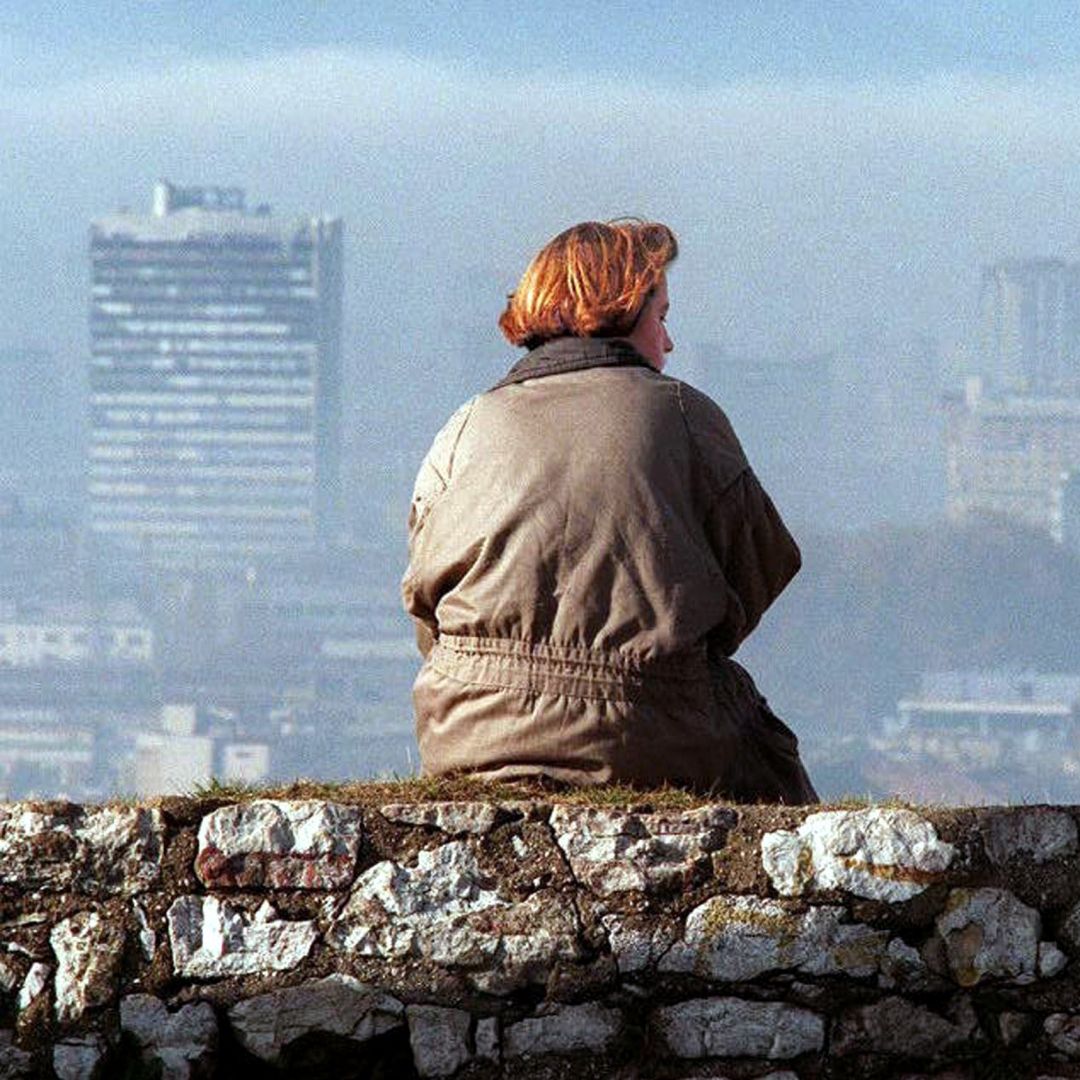 A Bosnia woman takes in the Sarajevo skyline from a location shielded from snipers, Nov. 17, 1995.