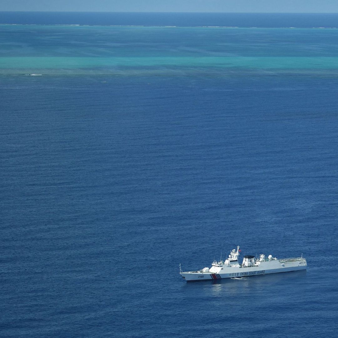 A photo taken during a Philippine surveillance flight on Sept. 28, 2023, shows a Chinese coast guard ship on patrol near the Scarborough Shoal (seen in the background) in the South China Sea. A photo taken during a Philippine surveillance flight on Sept. 28, 2023, shows a Chinese coast guard ship on patrol near the Scarborough Shoal (seen in the background) in the South China Sea.