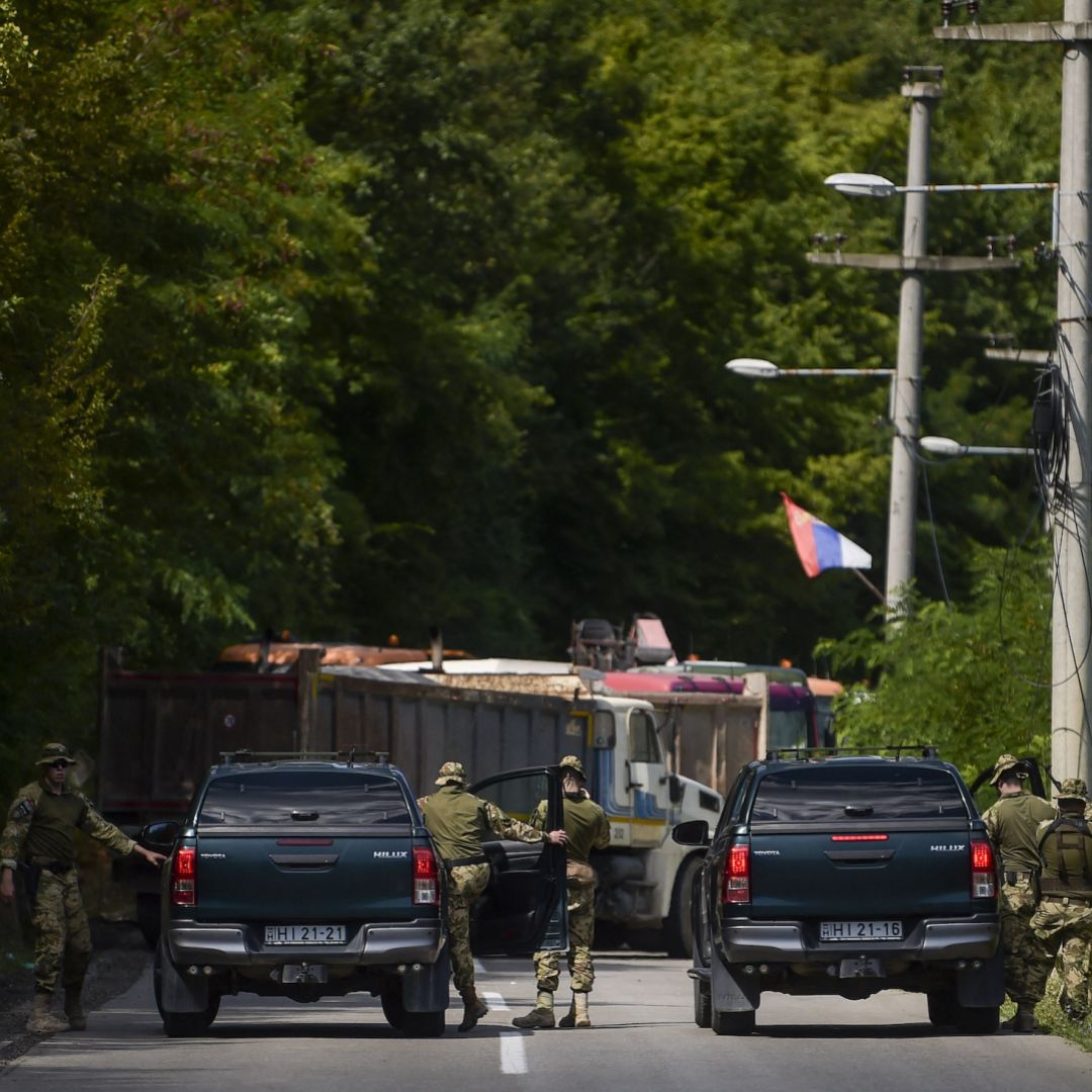 NATO soldiers serving in Kosovo patrol next to a road barricade set up by ethnic Serbs near the town of Zubin Potok on Aug. 1, 2022. 