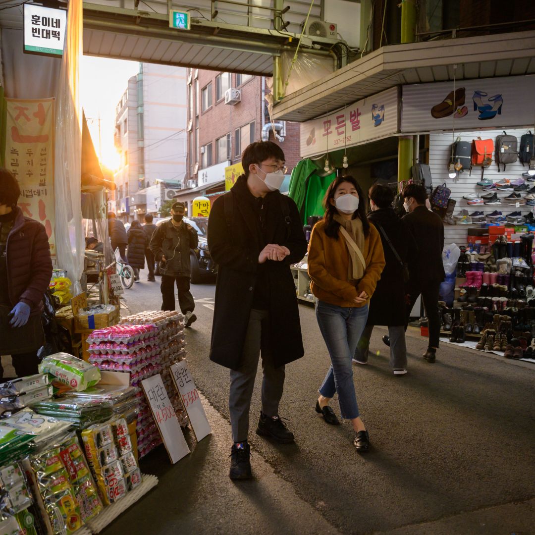 Shoppers wearing face masks amid concerns over the COVID-19 novel coronavirus outbreak in a market in Seoul, South Korea, on March 14, 2020.
