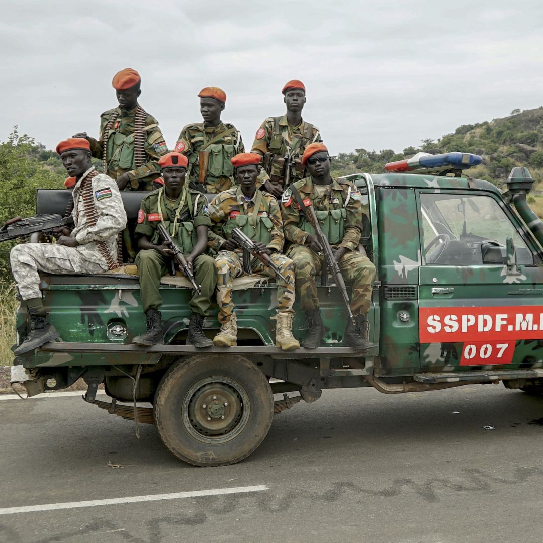 South Sudanese military police officers sit on a pickup truck as they monitor the area during a deployment ceremony for South Sudan's unified forces at the Luri Military Training Center in Juba on Nov. 15, 2023. 