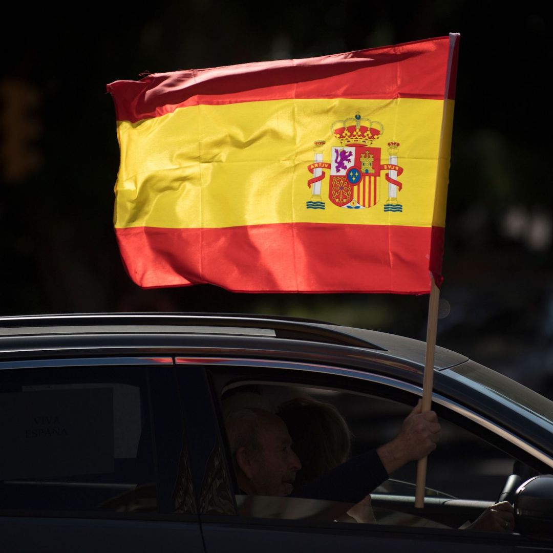 A driver waves a Spanish flag from his car during an anti-government demonstration organized by Spain's far-right Vox party in Malaga on Oct. 12, 2020. A driver waves a Spanish flag from his car during an anti-government demonstration organized by Spain's far-right Vox party in Malaga on Oct. 12, 2020.
