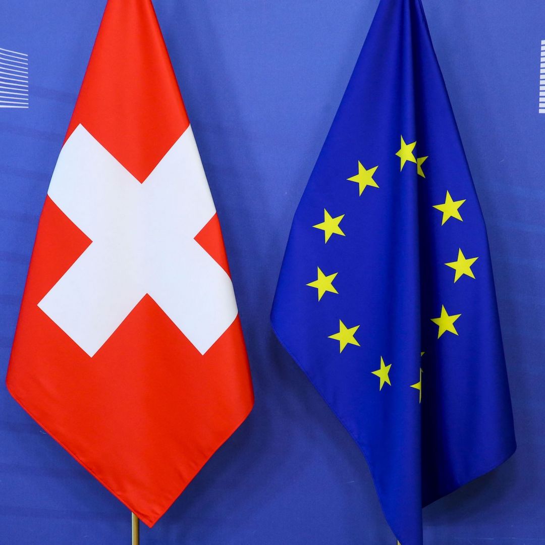 Switzerland's national flag (left) is pictured next to the EU flag at the European Commission building in Brussels, Belgium. 