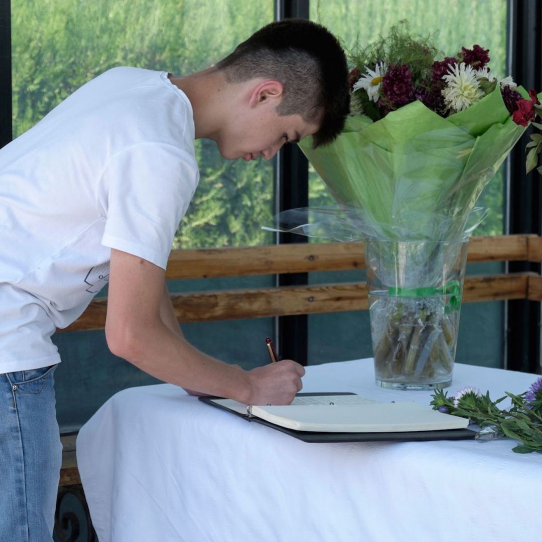 A man signs a condolence book at the U.S. Embassy in Dushanbe, Tajikistan, for the four bicyclists killed in a terrorist attack on July 29, 2018. A man signs a condolence book at the U.S. Embassy in Dushanbe, Tajikistan, for the four bicyclists killed in a terrorist attack on July 29, 2018.