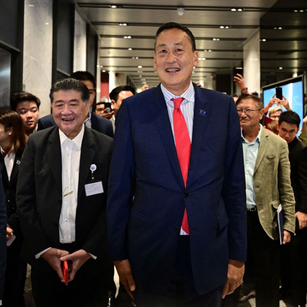 Thailand's newly appointed prime minister, Srettha Thavisin (center), greets supporters at his Pheu Thai Party's headquarters in Bangkok on Aug. 22, 2023.