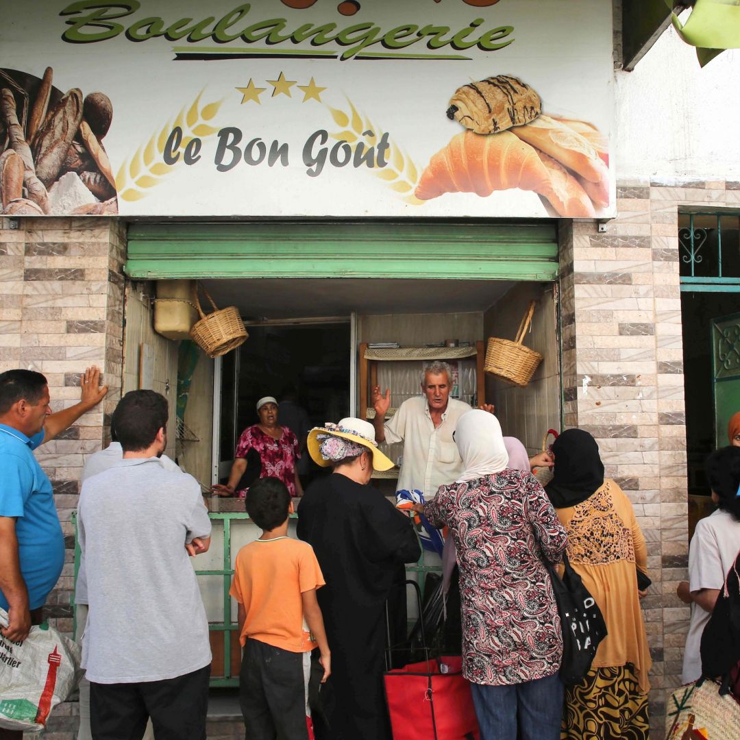 People line up in front of a bakery selling subsidized bread in Tunis, Tunisia, on Aug. 19, 2023.