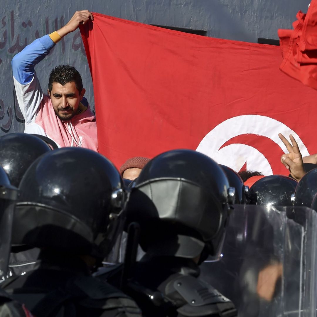 Police block protesters from accessing the parliament building on Jan. 26, 2021, in Tunis, Tunisia.  
