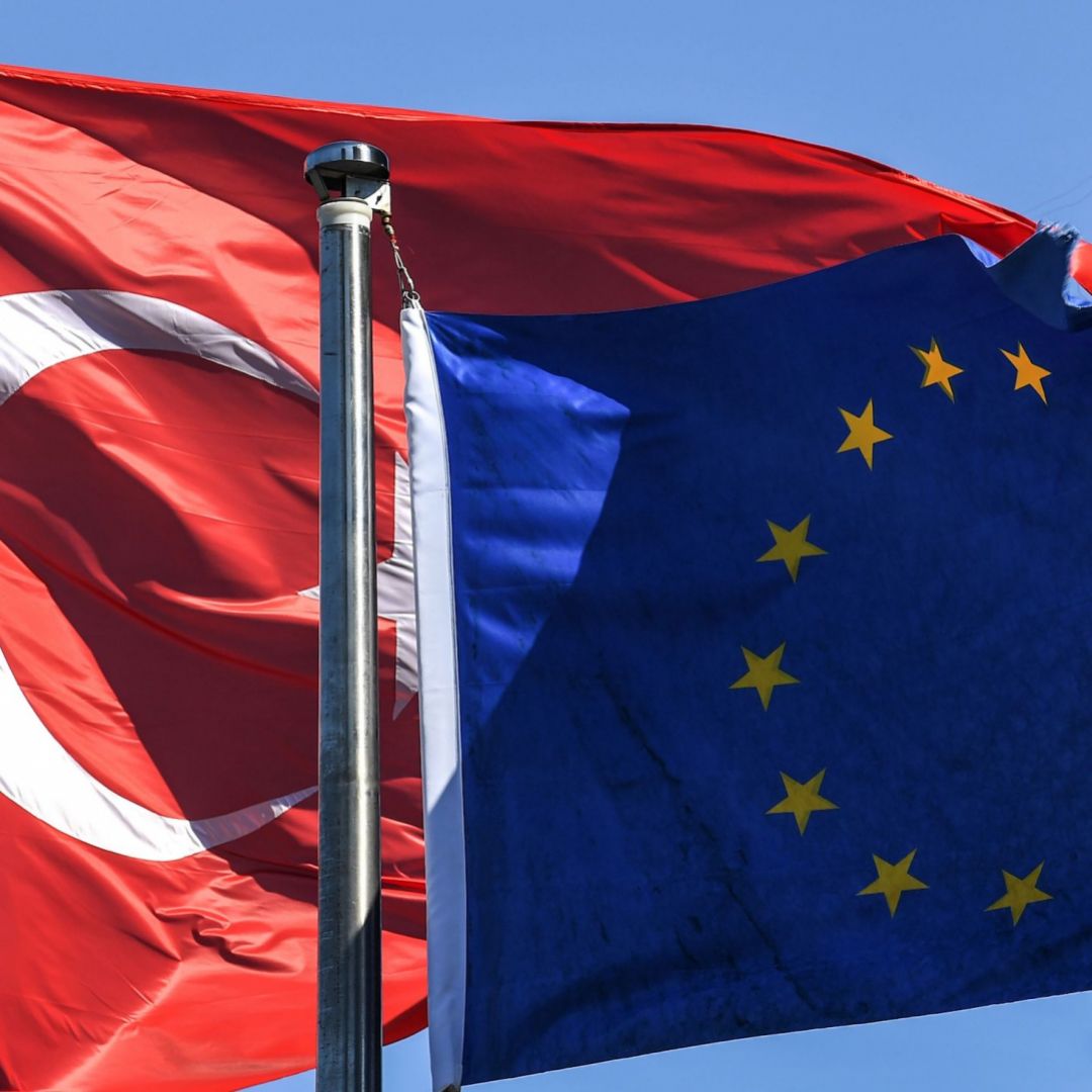The Turkish flag (left) waves alongside the EU flag in Istanbul in August 2018. 