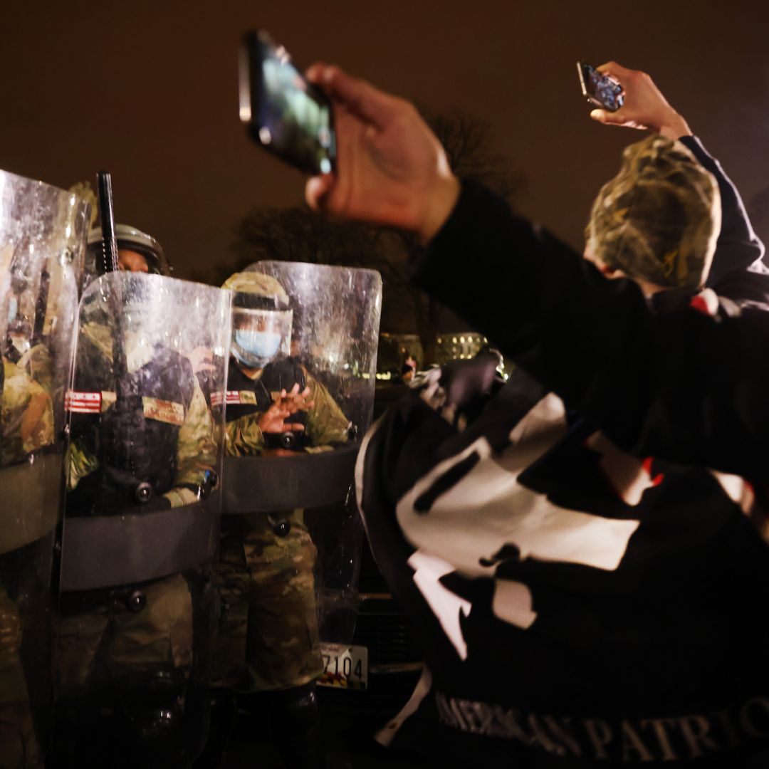 Members of the National Guard and the District of Columbia police keep a small group of protesters at bay after thousands of Trump supporters stormed the Capitol building following a 'Stop the Steal' rally on Jan. 6, 2021, in Washington.