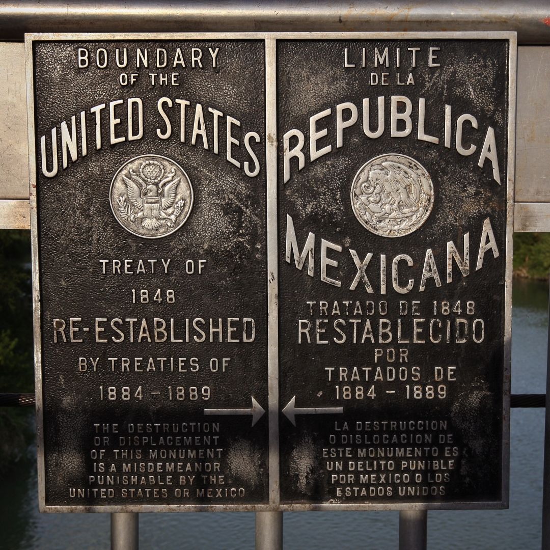 Signs mark the boundary between the United States and Mexico over the Rio Grande on Aug. 6, 2008, near Laredo, Texas.