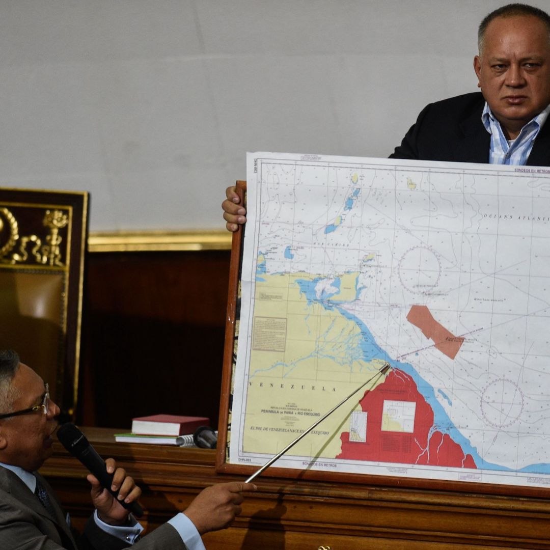 Venezuelan lawmaker Pedro Carreno (L) delivers a speech while Venezuelan deputy Diosdado Cabello (R) holds a map showing the border between Venezuela and Guyana during a legislative session in Caracas on Jan. 8, 2019.