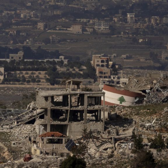 A Lebanese flag painted on a damaged building in the village of Meiss El-Jabal in southern Lebanon is seen from a position on the Israeli side of the border on Jan. 23, 2025, in northern Israel. A Lebanese flag painted on a damaged building in the village of Meiss El-Jabal in southern Lebanon is seen from a position on the Israeli side of the border on Jan. 23, 2025, in northern Israel.