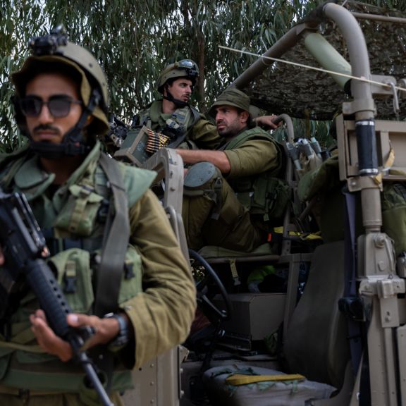 Israel Defense Forces soldiers guard an area around the Israeli settlement Kfar Azza on Oct. 10, 2023, after Hamas militants killed dozens of civilians there days earlier.